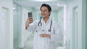 Happy Indian doctor talking on video call