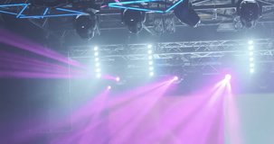 Pink rays motion of spotlights light in nightclub. Show illuminated with bright spotlight. Magenta spot light glow, shine on blue background. Professional lighting technology. Lamp beam moving video