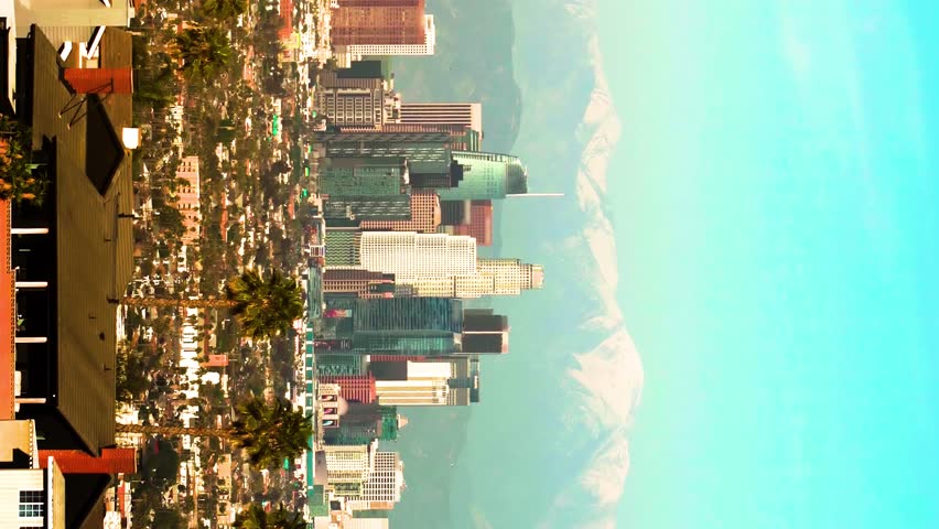 Los Angeles skyline over snowy mountains. Excellent footage of the skyline against snowy mountains in downtown Los Angeles, California. Vertical, vertical video background.