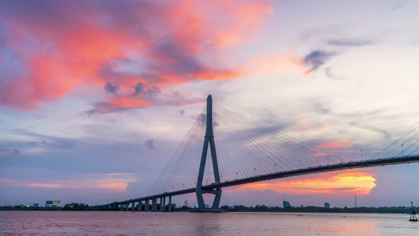 Timelapse of sunset Can Tho bridge, Vietnam. Cable-stayed bridge connecting road traffic in Vinh Long and Can Tho provinces for trade and commerce in the Mekong Delta Royalty-Free Stock Footage #1110044459