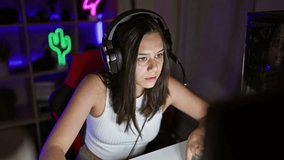 Stressed hispanic streamer, beautiful young woman overworked streaming gaming under duress at home