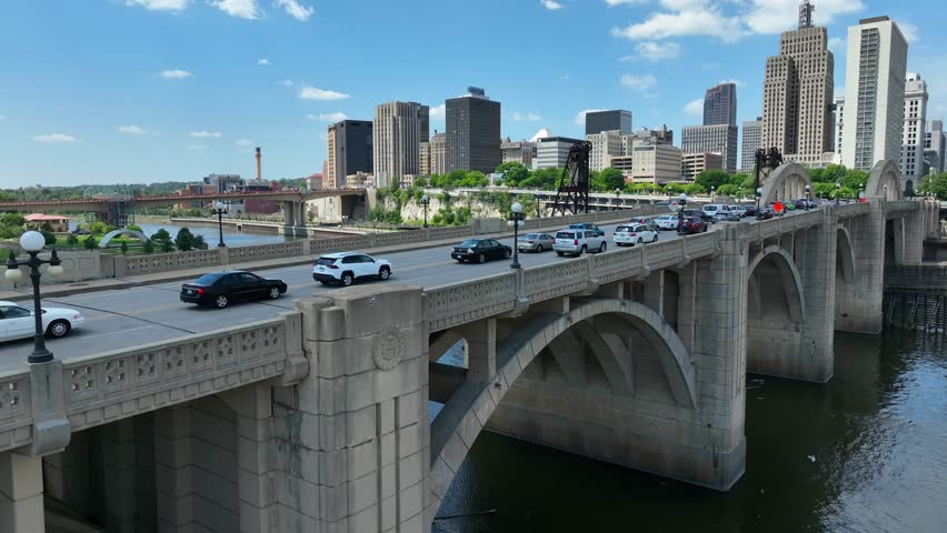 Aerial view of stone arches of the Robert Street Bridge over the Mississippi River. Saint Paul cityscape in the background on a beautiful summer day.