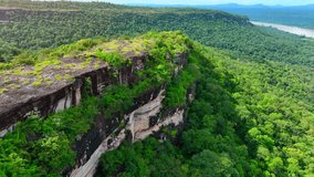 Pha Taem cliffs overlooking the majestic Mekong River, a breathtaking natural wonder from a bird's eye perspective. Pha Taem National Park, Ubon Ratchathani, Thailand. Nature and travel concept.
