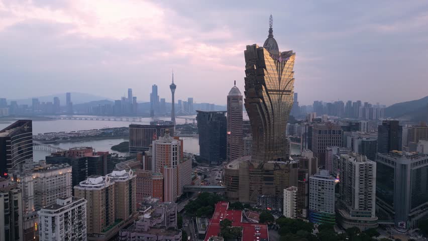 Macau, China - October 16 2023: Aerial drone footage of the famous Macao skyline with the iconic Grand Lisboa casino at sunset in Macau SAR in China. 