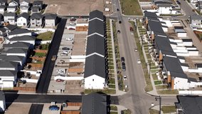 Aerial video of Brighton neighborhood in Saskatoon, SK, Canada. Captures the scenic urban layout, houses, and streets from a bird's-eye view. Ideal for urban planning and tourism. 