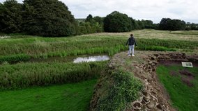 Aerial video footage of a young boy looking out on the the remains of Bolingbroke Castle.