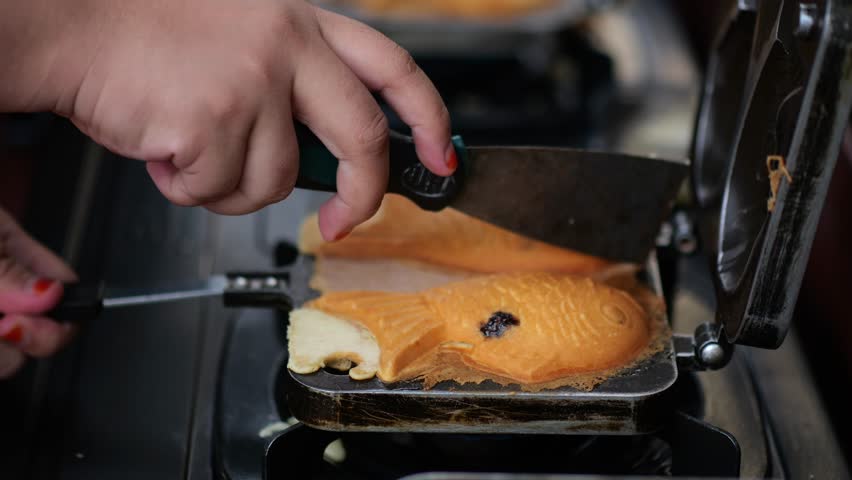 Korean style pancake (Bungeoppang) ,Fish-shaped bread with sweet red bean filling in South Korea,street food. Winter food - Hand preparing cooking Bungeoppang (fish-shaped bread) Royalty-Free Stock Footage #1110061847