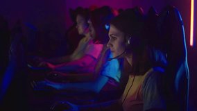 Female team is playing a match in a video game competition. Team is having an intense match up in an esports competition. The Female team is matched up against tough opponents in a gaming competition.