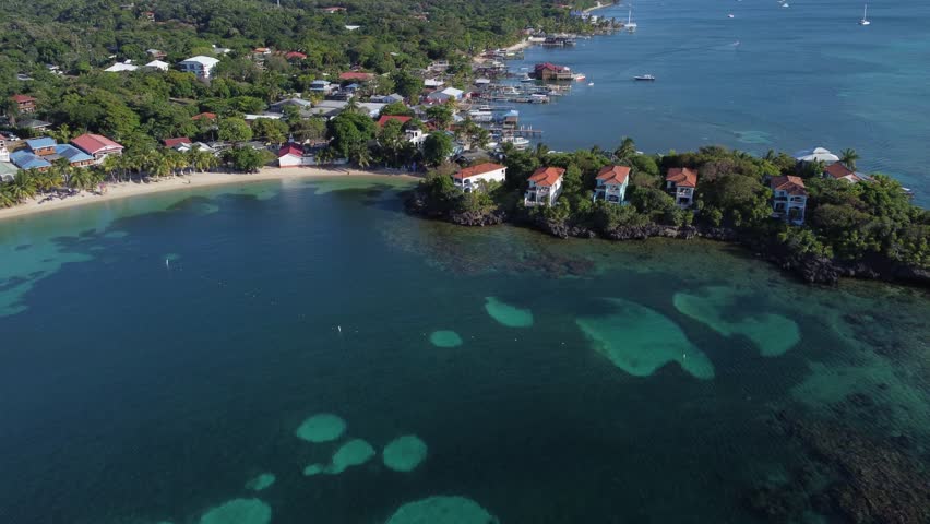 Flyover waterfront estate homes on coast of Caribbean Roatan, Honduras Royalty-Free Stock Footage #1110067433