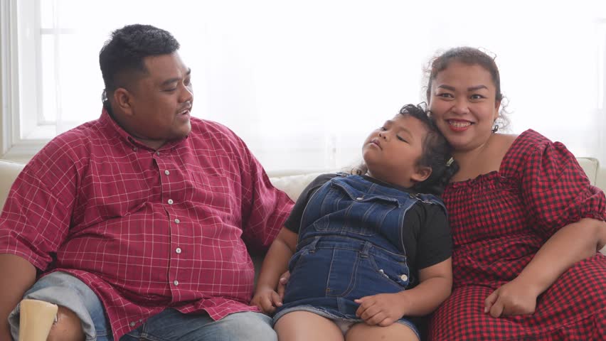 Asian angry and sad little girl in sofa with family. The emotion of a child when tantrum and mad.Kid expression grumpy emotion. Kid emotional control concept.