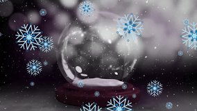 Animation of christmas snow globe over snow falling in winter scenery. Christmas, festivity, celebration and tradition concept digitally generated video.