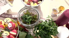 Pine cones in a glass jar are placed next to donuts on the table as a decorative element. - Powered by Shutterstock - Get 15% off with code: PIKWIZARD15