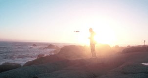 Technology, photography and man on beach with drone to film nature, water or sunset. Video photographer in test flight for device, aerial recording and videography at ocean for high tech surveillance