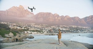 Technology, videography and man on beach with drone to film nature, water or sunset. Video photographer in test flight for device, aerial recording and photography at ocean for high tech surveillance