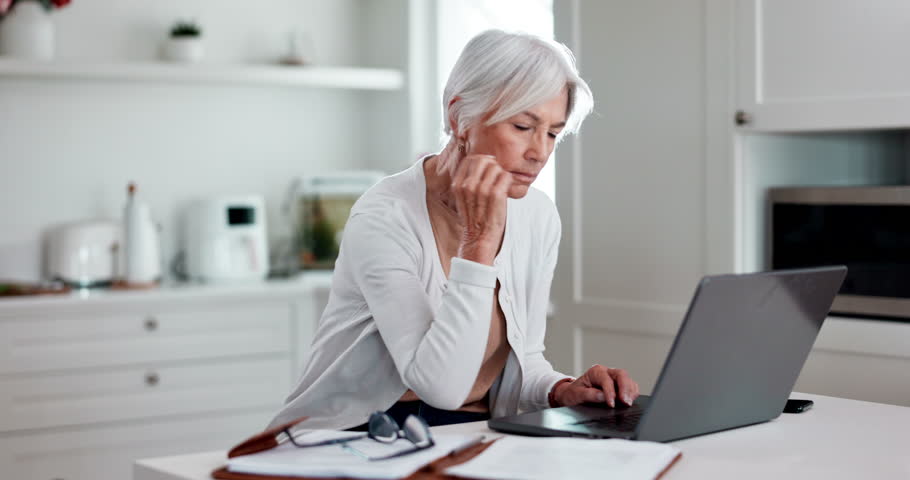 Senior woman, laptop and home for online research, asset management and planning retirement or pension application. Serious, mature person on computer of life insurance, policy or website information Royalty-Free Stock Footage #1110072993