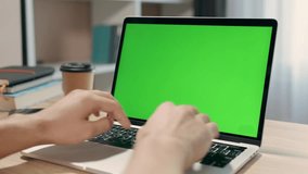 Young Man Uses Laptop With Green Mock-up Screen for Work or Study in Cozy Home Office. Close-up Of Chroma Key Display - Powered by Shutterstock - Get 15% off with code: PIKWIZARD15