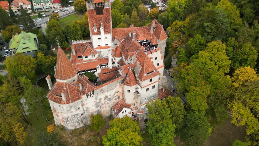 Aerial drone shot of Bran Castle in autumn. Medieval Bran Castle in Transylvania, Romania. The mystic Count Dracula's Castle is located in Bran, near the town of Brasov.  Royalty-Free Stock Footage #1110074141
