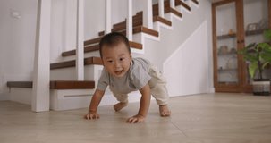 Happy child kid boy. Cinematic Asian. Baby barely stands up and happy runs towards camera, grabbing lens. Carefree happy childhood. Baby trying to hug camera smiling playing