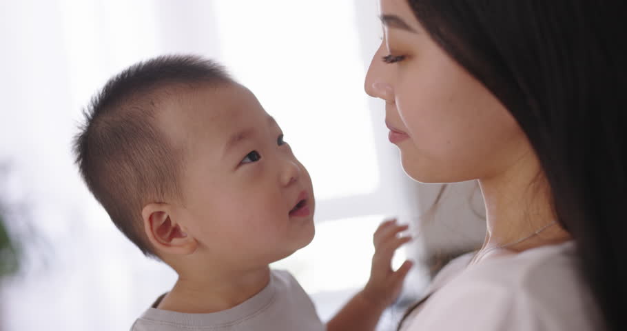 Mother and son face to face. Adorable infant baby boy son playing with Asian mom at home. Happy family learning funny games having fun enjoying sweet moments together Royalty-Free Stock Footage #1110074453