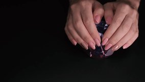 This 4K video captures a close-up of a pink manicure with sparkles.