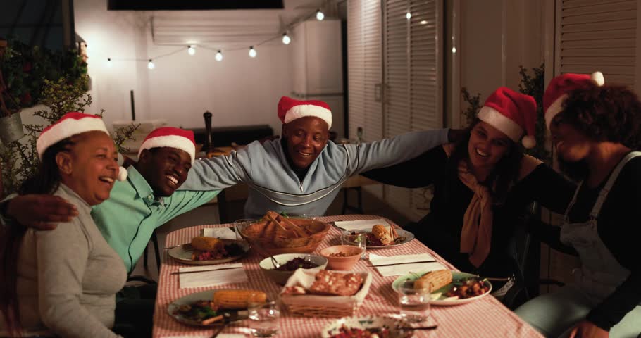 Happy african family having fun singing and dancing together during Christmas eve dinner wearing santa claus hat - Holiday concept Royalty-Free Stock Footage #1110080561