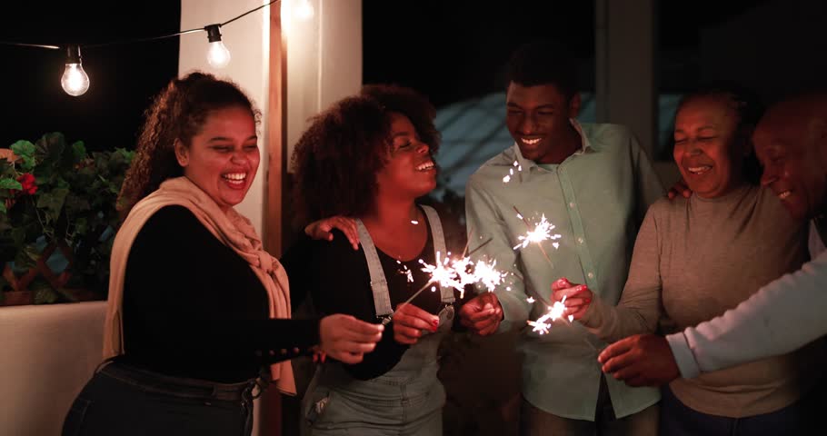 African family having fun hugging each other and celebrate during new year's eve with firework sparkler Royalty-Free Stock Footage #1110080567
