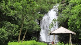 Spectacular waterfall in canyon forest.Heart-shaking flowing water, lush green trees, and quaint pavilion form a scenic scene.High quality video photography in Shenying Fall, Laiyi , Pingtung,Taiwan.