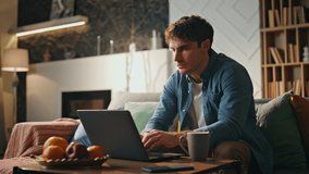 Busy programmer working laptop at home late evening. Focused tired businessman looking computer screen surfing internet searching information. Young freelancer solving problem remotely sitting couch. - Powered by Shutterstock - Get 15% off with code: PIKWIZARD15