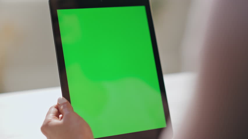 Woman hands swiping green screen tablet watching social media at home close up. Unknown businesswoman using mockup pad computer touching scrolling display indoors. Lady working at chroma key device.