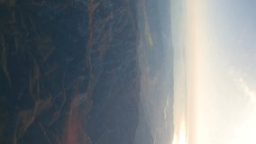 Airplane flight. View from the window of the plane. Traveling by air. Vertical, vertical video background.