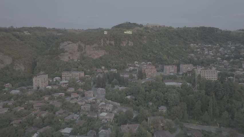 Aerial view of the Chiatura miners city in Imereti province, Georgia. Drone footage of the Chiatura cityscape in summer. Ungraded D-Log