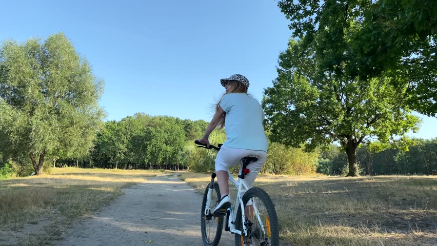 A woman rides a bicycle. Women