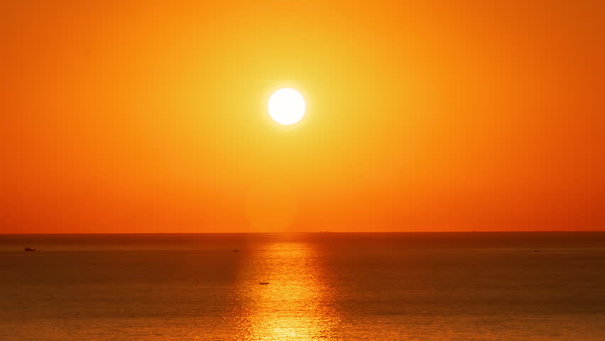 A Golden Idyllic Sunset Over The Ocean Time Lapse. The Evening Sun at The Golden Hour Sets Over The Calm Surface of The Sea.