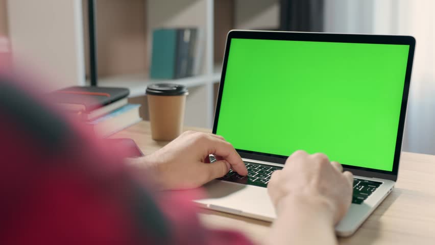 Young Man Uses Laptop With Green Mock-up Screen for Work or Study in Cozy Home Office. Close-up Of Chroma Key Display | Shutterstock HD Video #1110100879