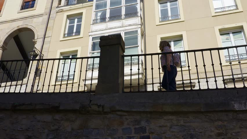 Woman strolling through the streets of the old town of the monumental city of Vitoria, Spain.