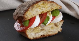 Close-up footage of a caprese sandwich on the rotating table.