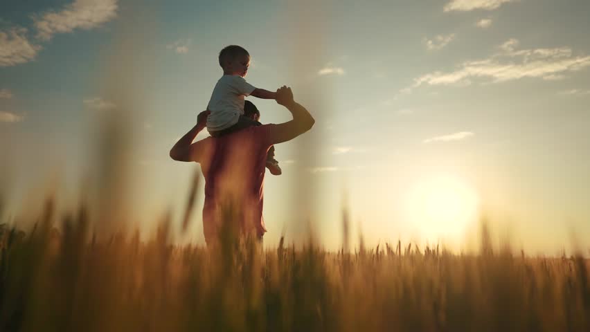 dad holds baby on his neck. landscape nature fresh air sun glare. fun family time. dad plays a with son happy family dream content lifestyle Royalty-Free Stock Footage #1110113697