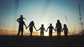 big family. huge family silhouette walking in park at sunset holding hands. big family kid dream concept. friendly community family walking in lifestyle nature with children at sunset - Powered by Shutterstock - Get 15% off with code: PIKWIZARD15