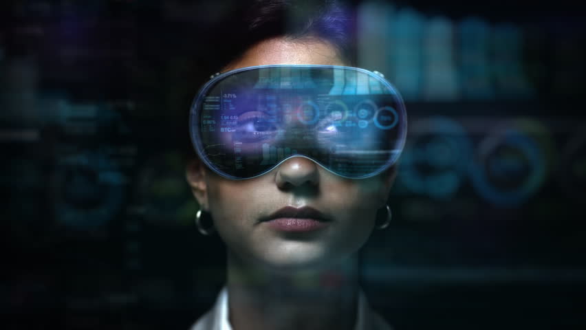 Dolly In of Young Female Financial Broker Working with VR Glasses. Augmented Reality Headsets with Economy Elements appearing. Charts, Graphs and Stock Exchange Data.
 - Powered by Shutterstock - Get 15% off with code: PIKWIZARD15