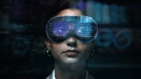 Dolly In of Young Female Financial Broker Working with VR Glasses. Augmented Reality Headsets with Economy Elements appearing. Charts, Graphs and Stock Exchange Data.
 - Powered by Shutterstock - Get 15% off with code: PIKWIZARD15