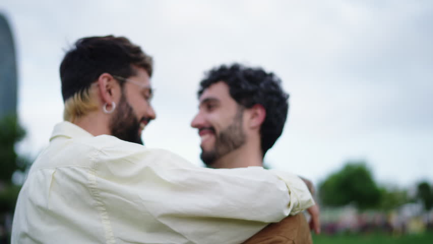 Happy carefree gay guys dancing and hugging in the park together, enjoying recreation time on weekend. `Romantic Lgbt couple in great mood playing around and dancing, feeling love and freedom Royalty-Free Stock Footage #1110119873
