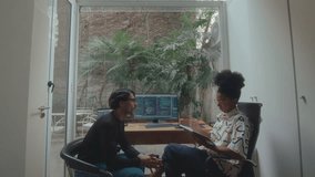 Young African-American woman taking notes and discussing computer code on PC with male coworker while developing software together in cozy home office. Zoom shot - Powered by Shutterstock - Get 15% off with code: PIKWIZARD15