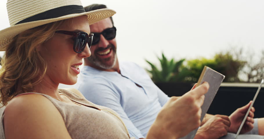 Love, relax and a couple reading books in the garden while on holiday or vacation together in summer. Smile, home or backyard with a mature man and woman on a break or getaway for their anniversary