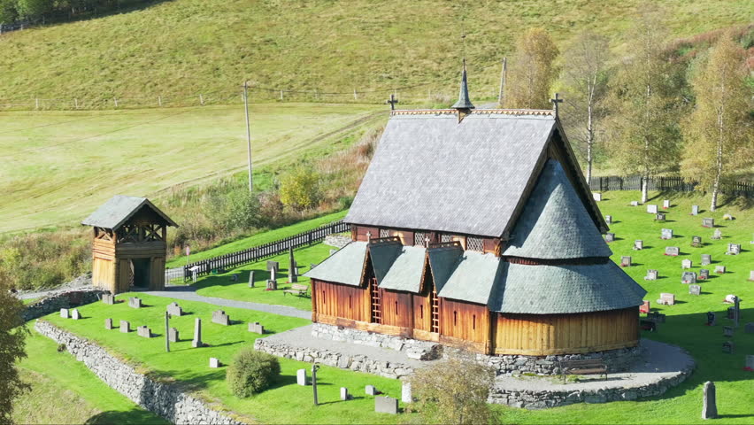 Drone orbit Reinli stave church with cemetery in Valdres, Norway