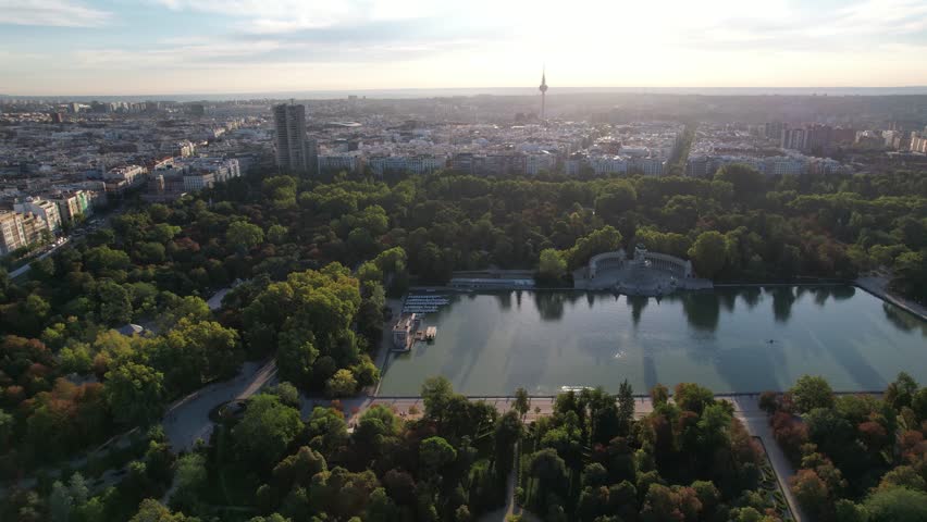 Aerial 4k drone view of Parque El Retiro in Madrid, Spain at a golden hour sunrise