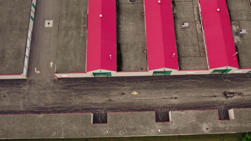 Aerial of a rental public storage, One way road for auto vehicles to drive to your storage unit. Red roofing. Pleasing high angle with garages placed in a beautiful pattern. Great for copy space.