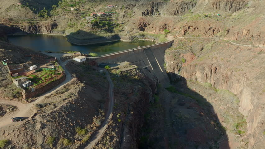 aerial view traveling in towards the Ayagaures dam and Angostura dam on a sunny day. On the island of Gran Canaria.