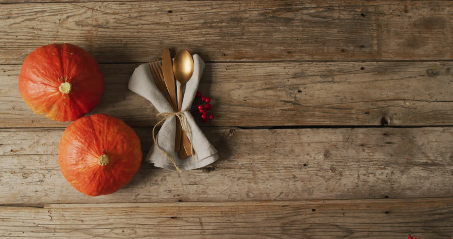 Animation of autumn leaves over thanksgiving dinner place setting background. Thanksgiving, american tradition and celebration concept digitally generated video. Royalty-Free Stock Footage #1110134637