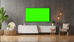 Close-up of TV screen with green background. Concept. Plasma TV screen with green screen. Modern TV on bedside table with green screen for insertion in house 