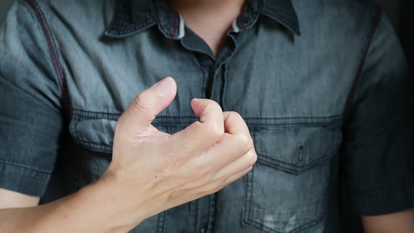 The man's hand has pain and Trigger finger from work and office syndrome. He relieves pain. With acupressure massage On a white background medical concept